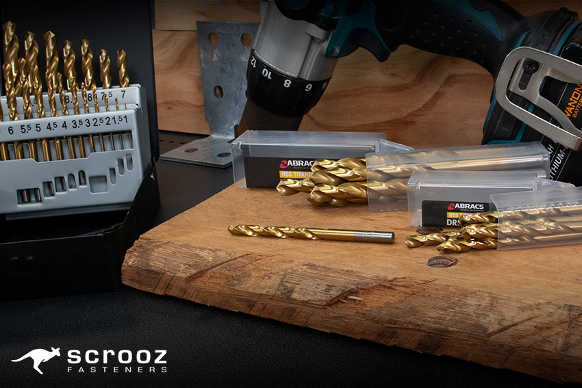 Drill Bits HSS by Scrooz - Abracs HSS Drill Bits for the drilling of wood, metal, and plastic. Displayed on wood and metal background with drill