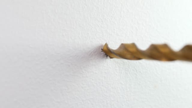 drilling a hole in a plasterboard wall