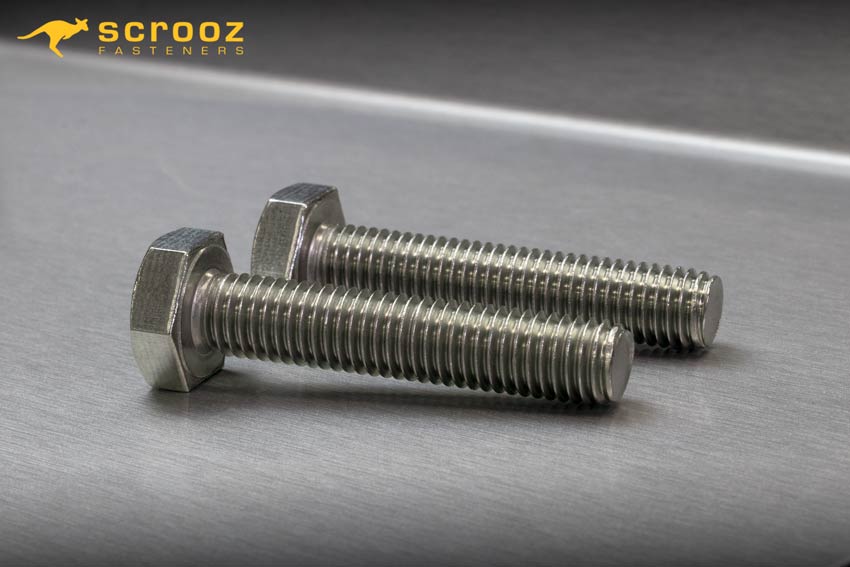Hex bolts full thread stainless main image. Two stainless steel full thread bolts on a metal background
