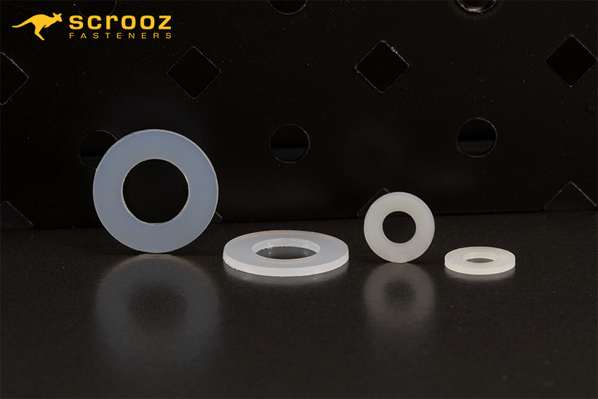 Nylon washers on a dark background. Two different sizes shown.