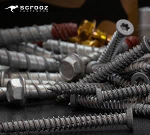 concrete screws and anchor bolts fixed in a block of concrete