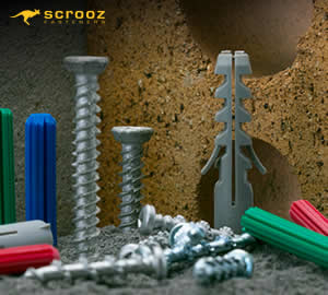 a group of plastic and nylon wall plugs on concrete and fixed into a brick
